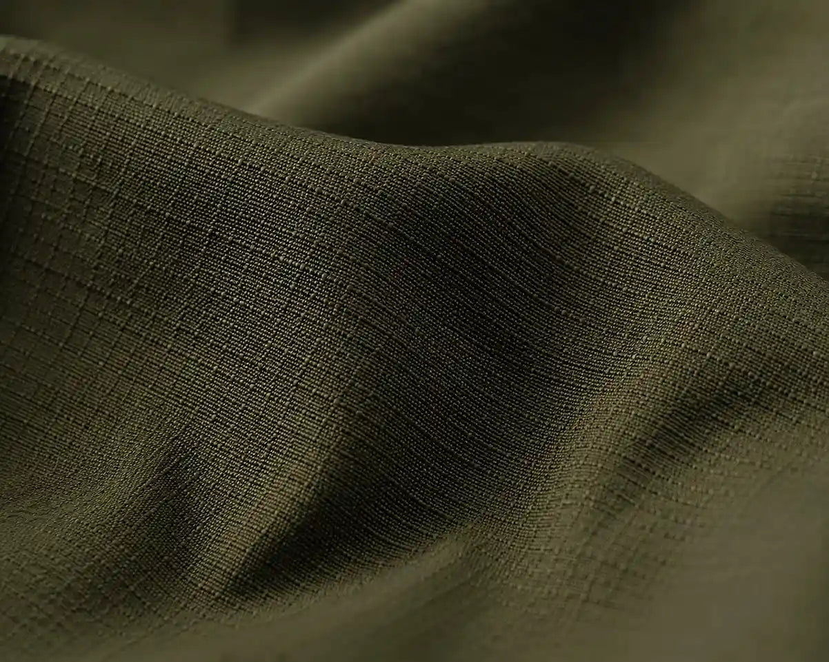 Close-up of dark green fabric with a textured surface