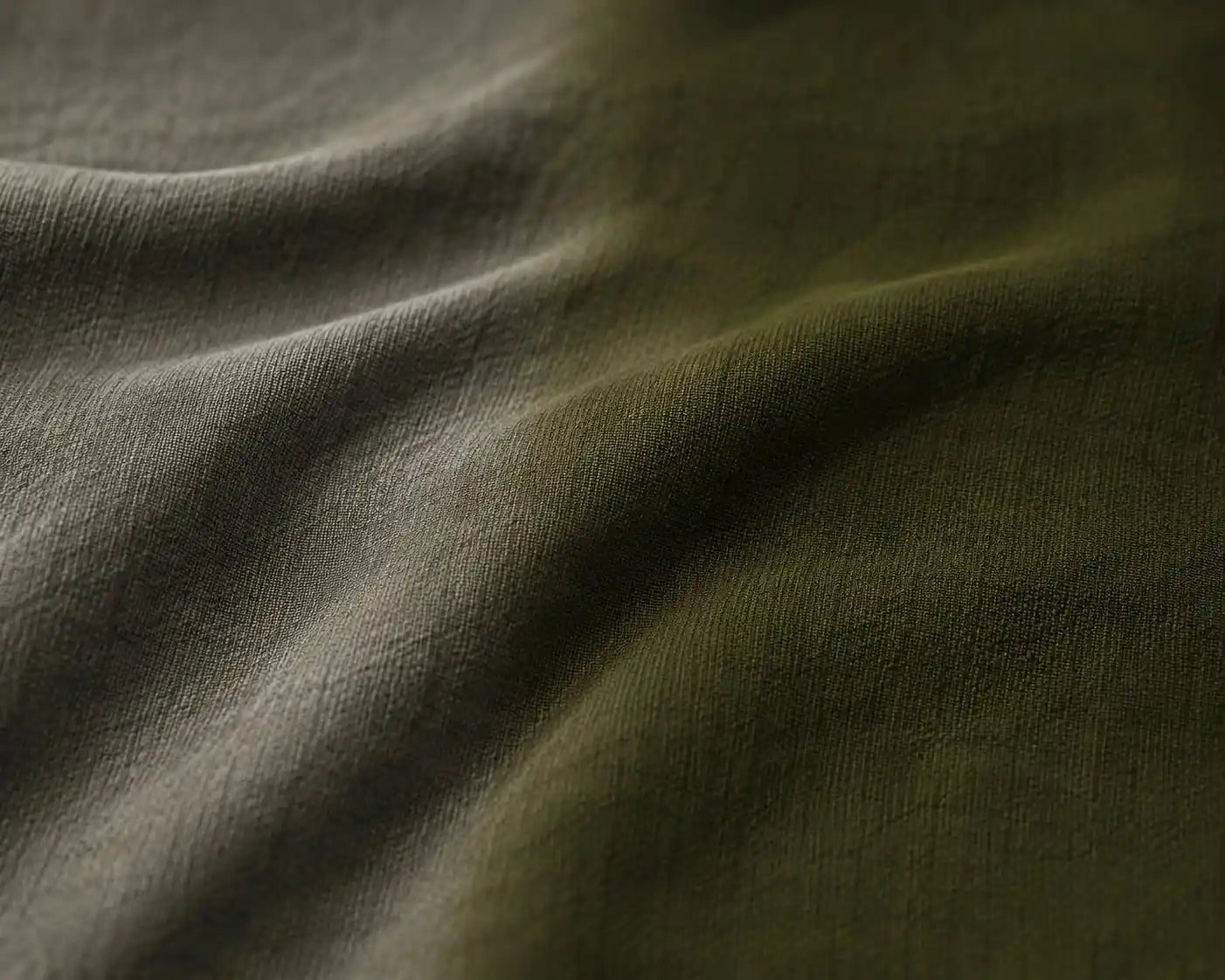 Close-up of textured green fabric with folds